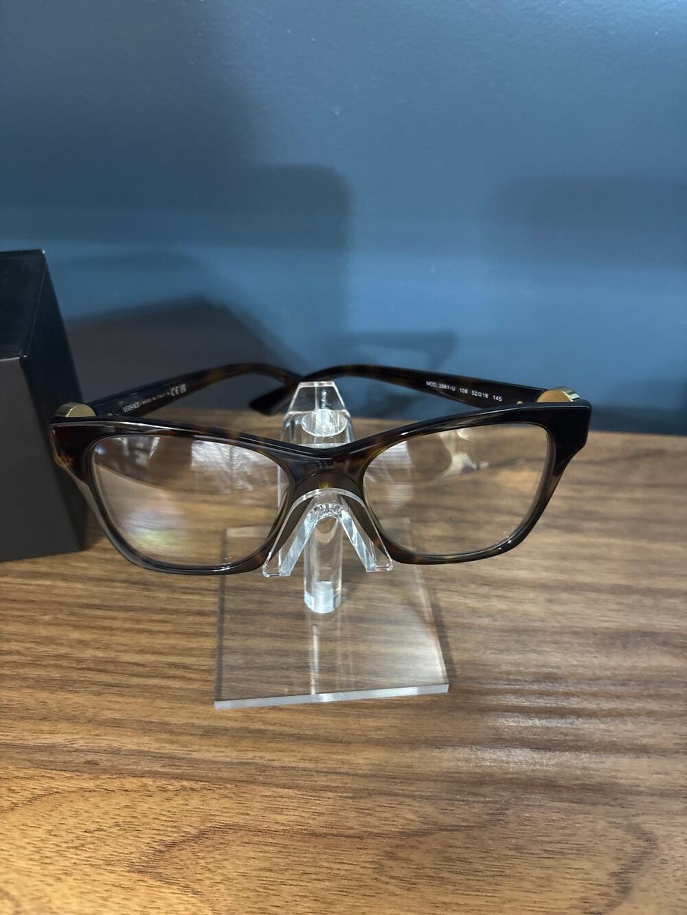 Versace eyeglasses feature a distinct Medusa plaque on the temple. Preloved.